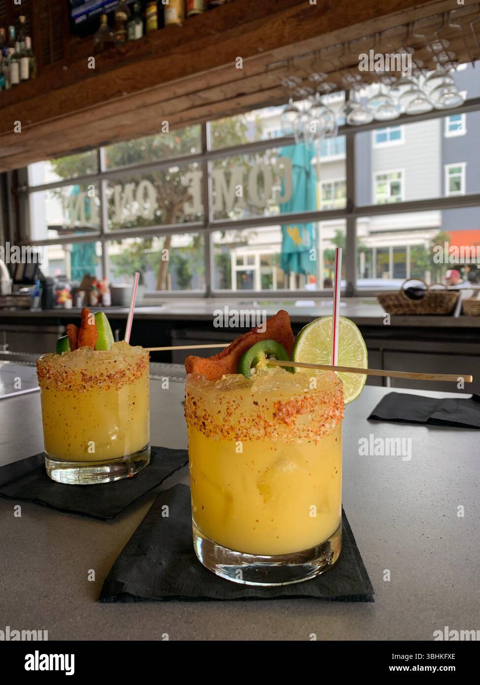 Two margaritas with tajin rims, jalepenos, and lime - Smartphone Captured Stock Image