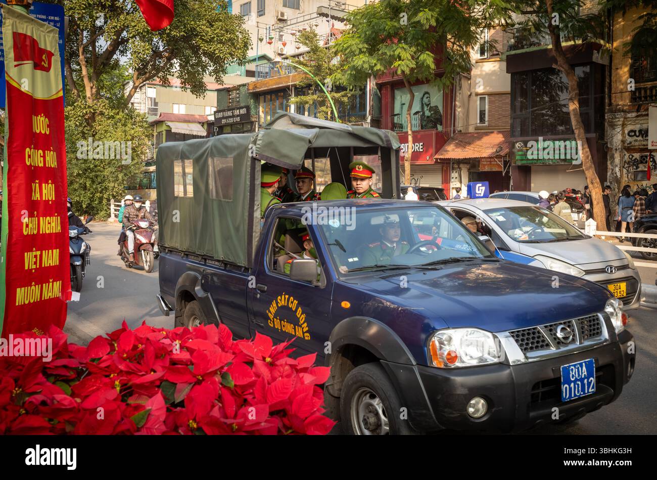 A group of Vietnamese riot police, or mobile police, in a blue truck ...