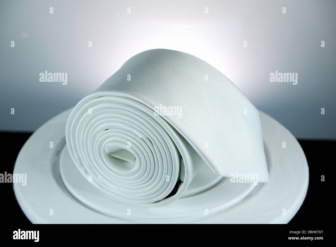 Rolled tie closeup shot against white background Stock Photo
