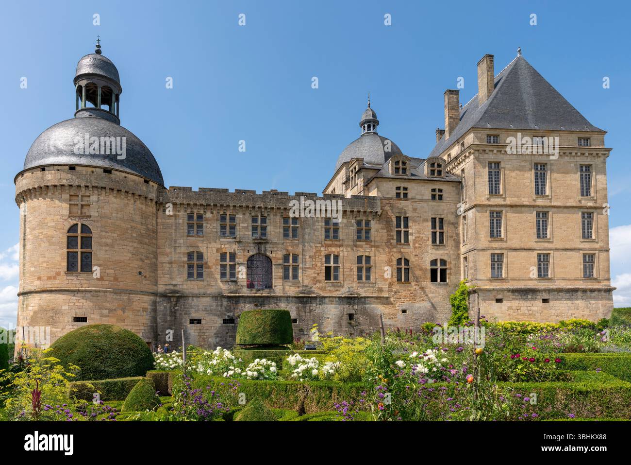 Historic castle with formal gardens and manicured topiary creating ...