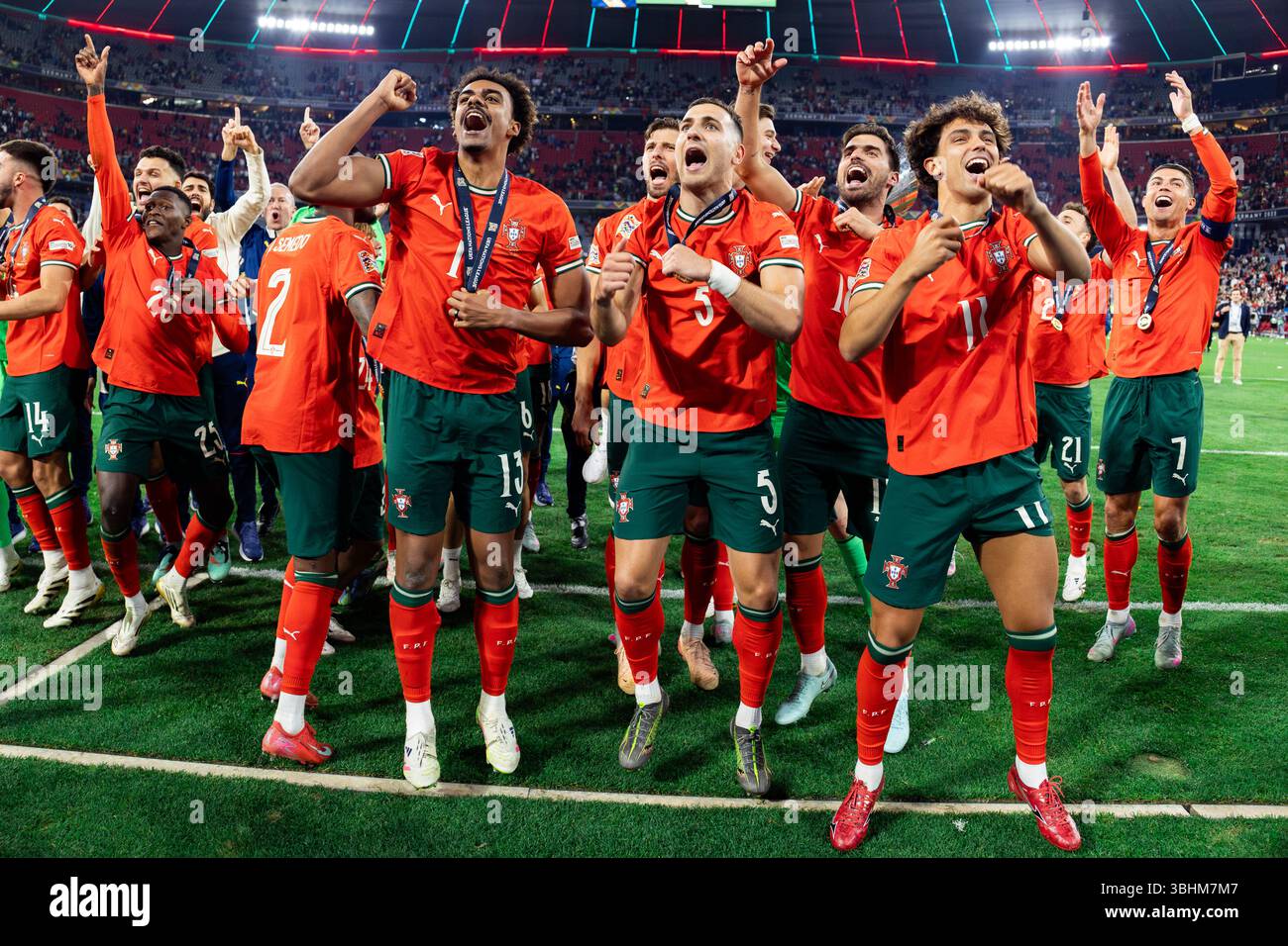 (L-R) Nuno Mendes, Renato Veiga, Diogo Dalot, Ruben Neves, Joao Felix, Cristiano Ronaldo and teammates of Portugal celebrate a win during the ceremony after the UEFA Nations League 2025 final match between Portugal and Spain at Munich Football Arena. Final score: Portugal 2:2 (penalties 5:3) Spain. Stock Photo