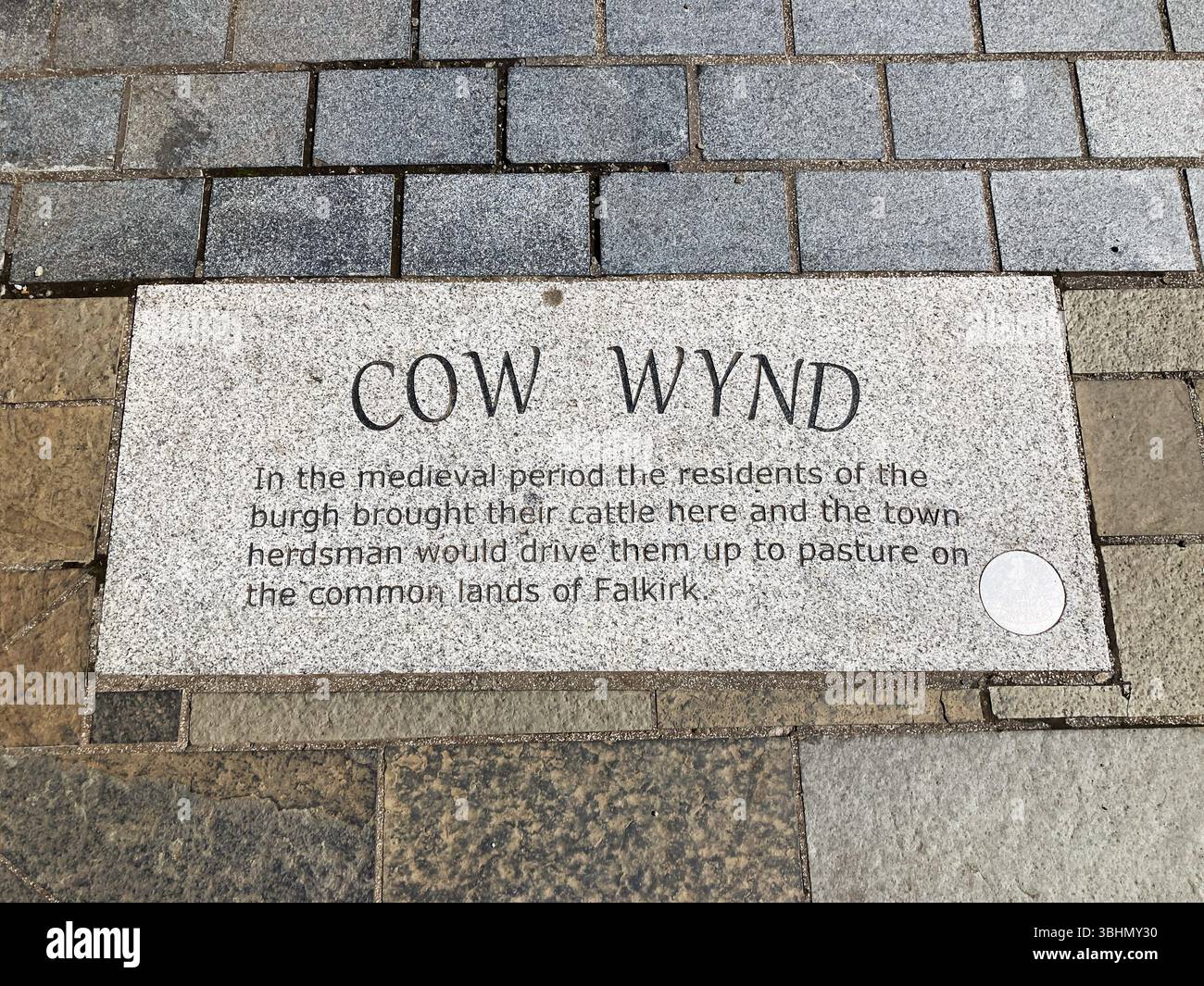 Inscription on the pavement with public information regarding The Cow Wynd, Falkirk Scotland - Smartphone Captured Stock Image