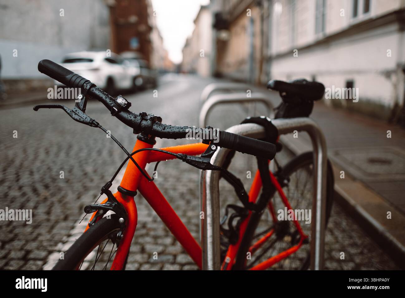 Orange bicycle stands on the orange bicycle park Stock Photo