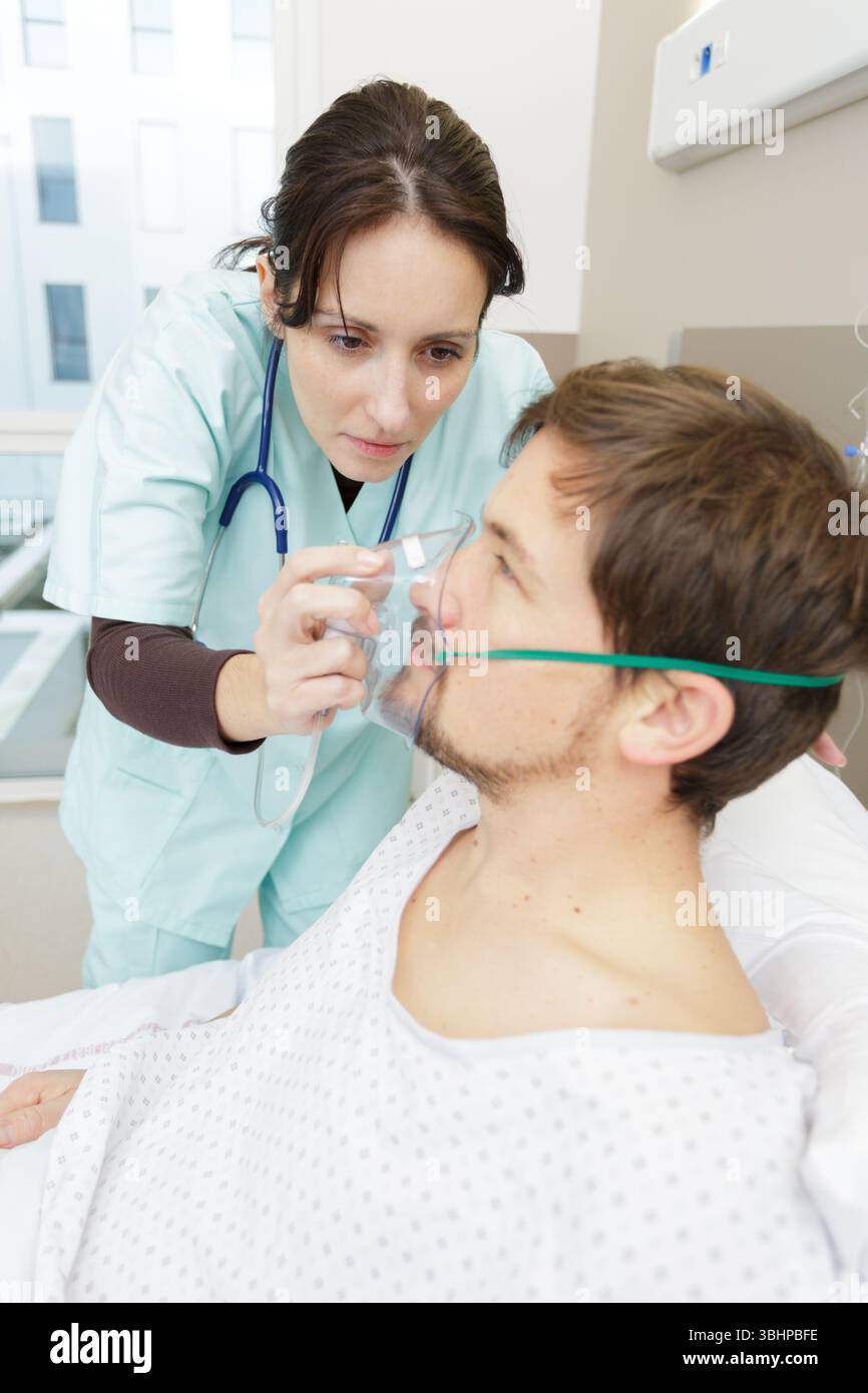 Female nurse placing oxygen mask hi-res stock photography and images ...
