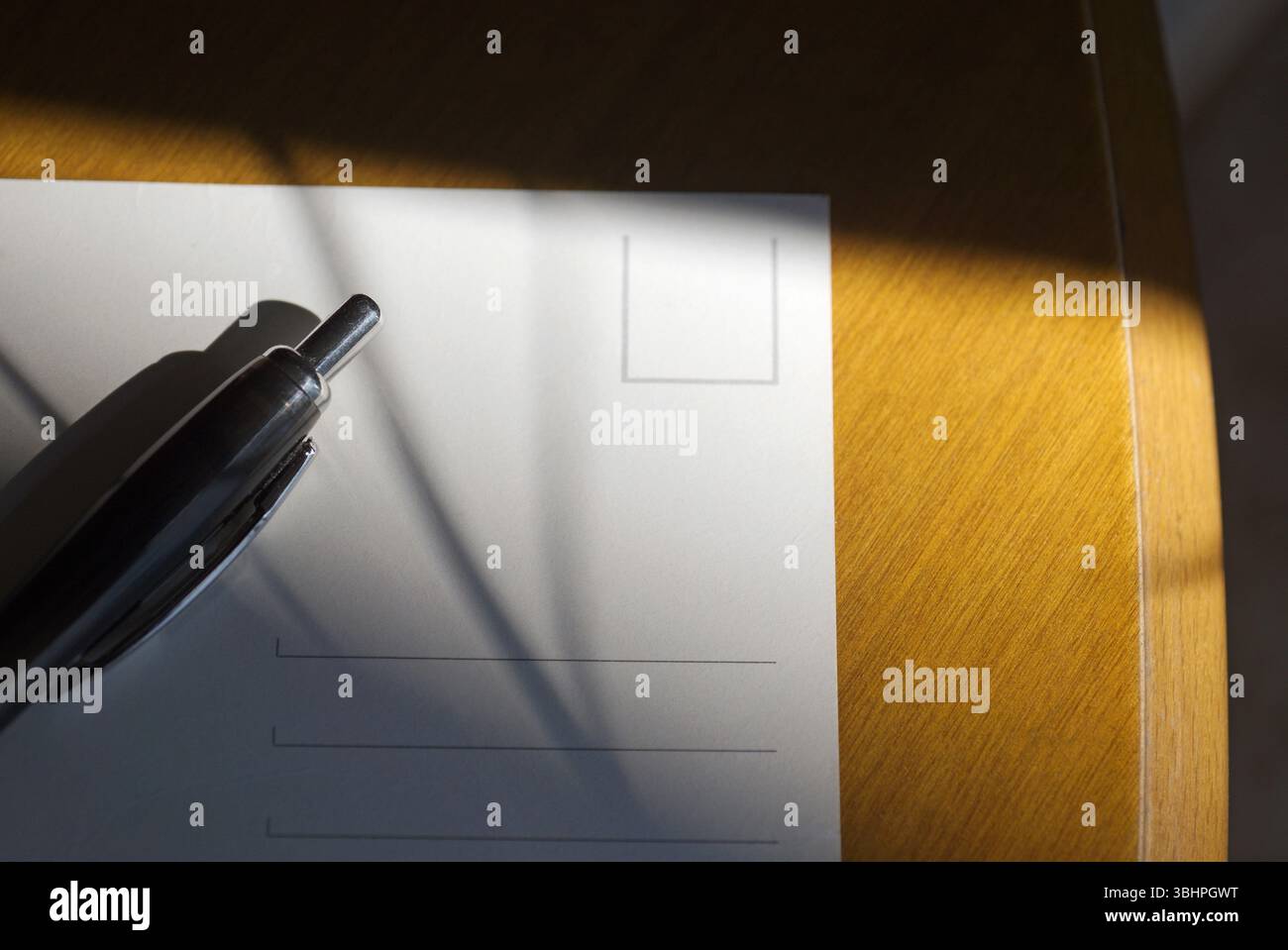 pen and white postcard on table Stock Photo