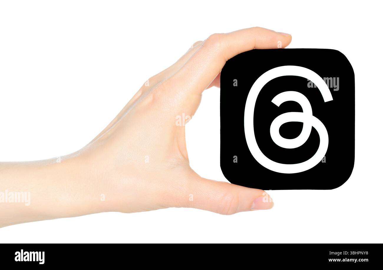 Hand holds paper Threads mobile app icon, on a transparent background ...