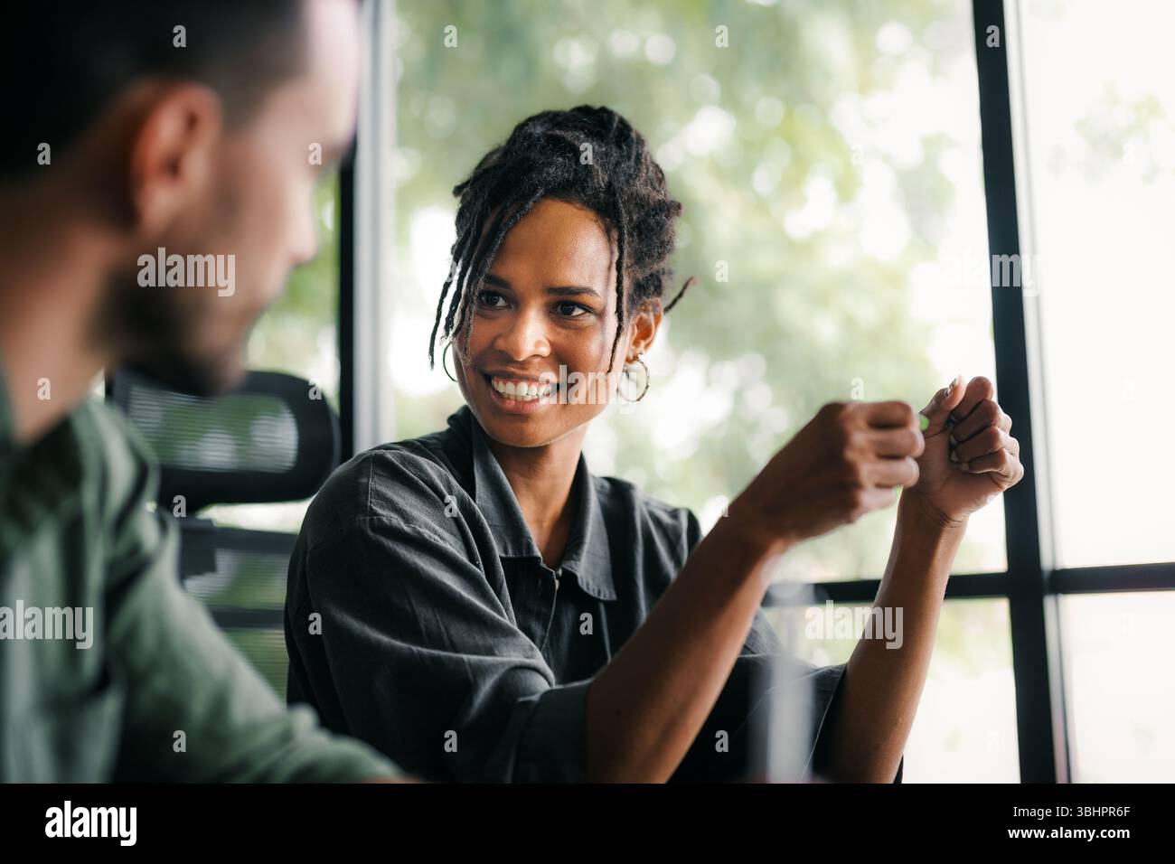 Cheerful diverse coworkers having fun during work break using technology enjoying working together Stock Photo