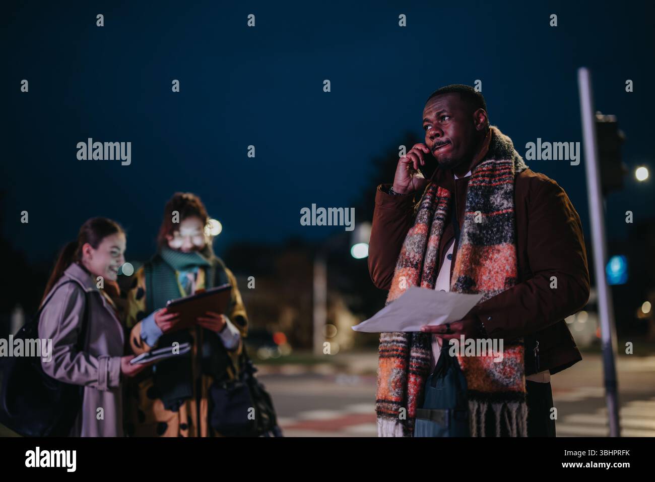 Professionals Collaborating Outdoors During the Evening Stock Photo