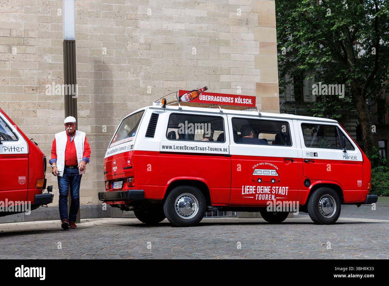 sightseeing bus VW T3 on Gereonskloster, Cologne, Germany. ###EDITORIAL USE ONLY###  Sightseeing-Bus VW T3 am Gereonskloster, Koeln, Deutschland. Stock Photo