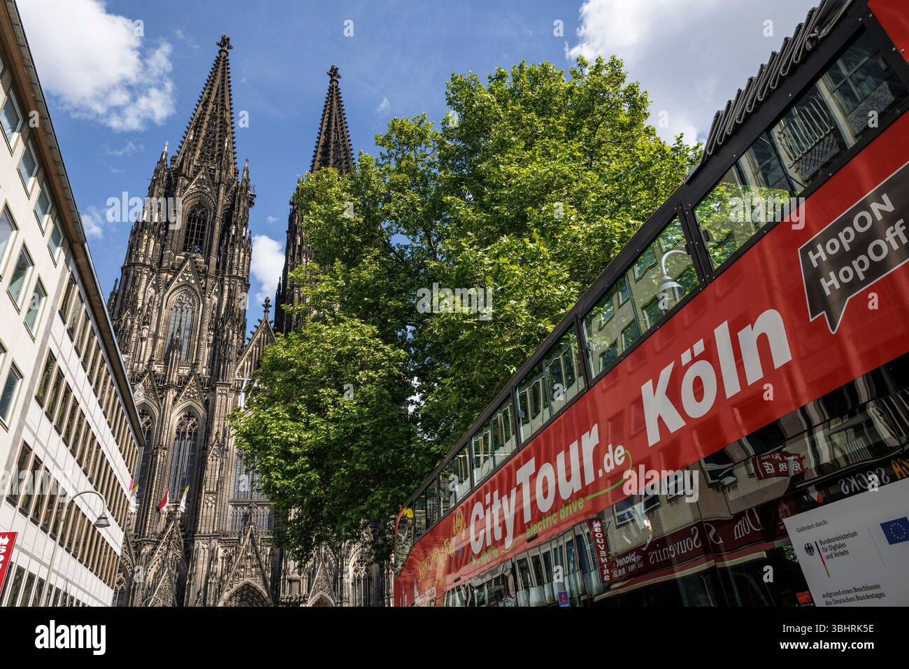 sightseeing bus in front of the cathedral, Cologne, Germany. Sightseeing-Bus vor dem Dom, Koeln, Deutschland. Stock Photo