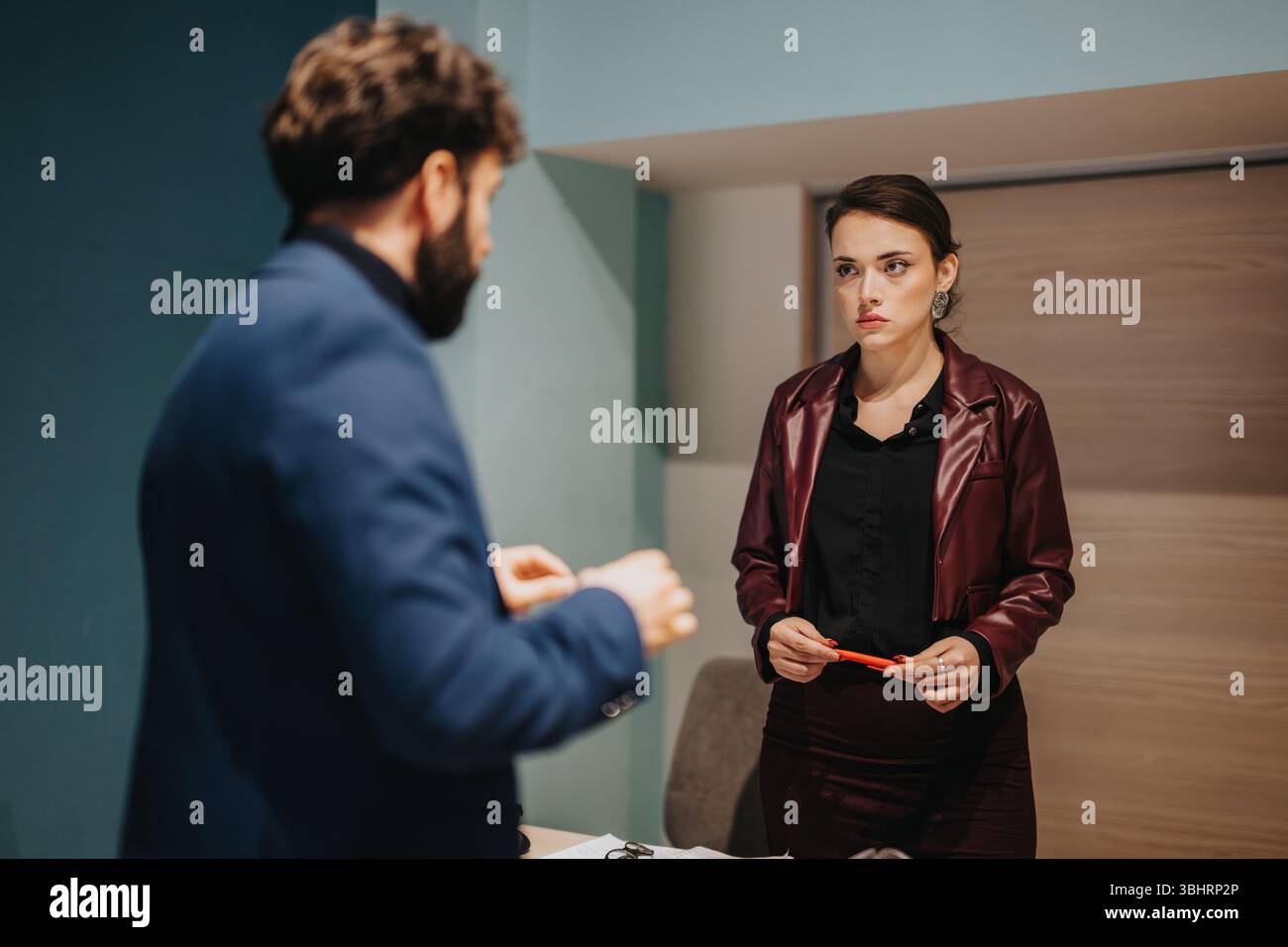 Two Professionals Engaged in a Serious Office Discussion Stock Photo