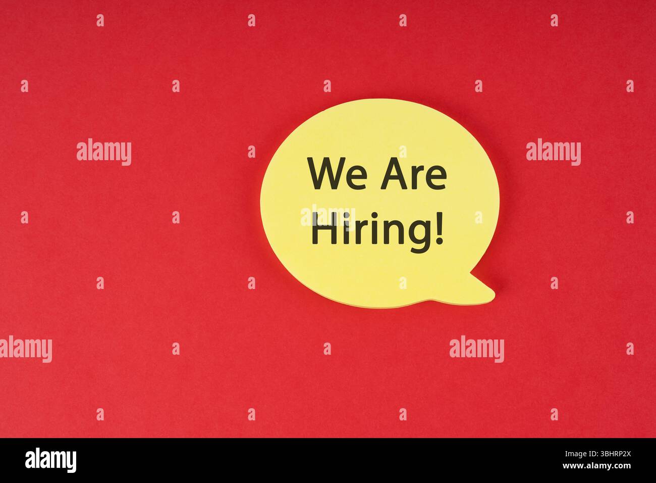 Yellow speech bubble with "We Are Hiring!" text on a red background. Stock Photo