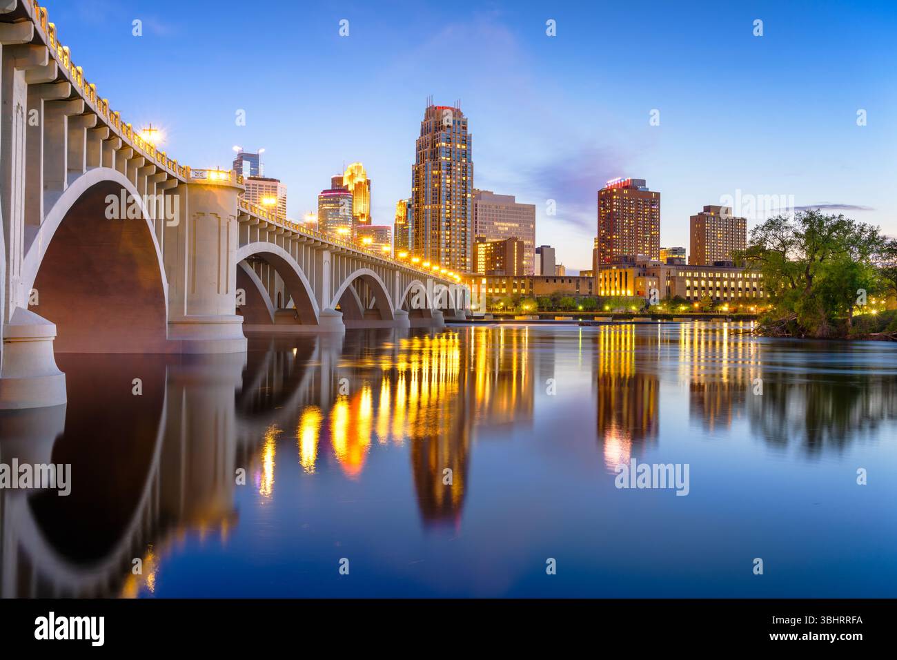 Minneapolis, Minnesota, USA downtown skyline on the Mississippi River with the Third Avenue Bridge at twilight. Stock Photo
