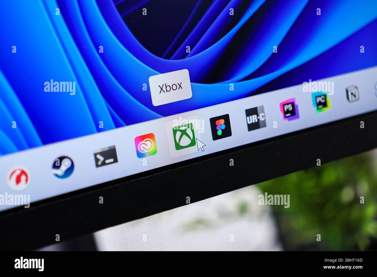 Poznan, Poland - June 6, 2025: Xbox application icon clearly visible on a modern Windows 11 taskbar, with a mouse cursor actively selecting the digita Stock Photo