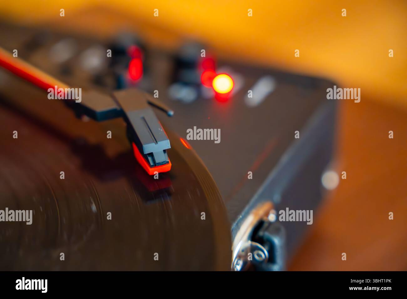 Close-up of record player needle tracking vinyl grooves during playback. Analog sound detail capturing retro music atmosphere. Stock Photo