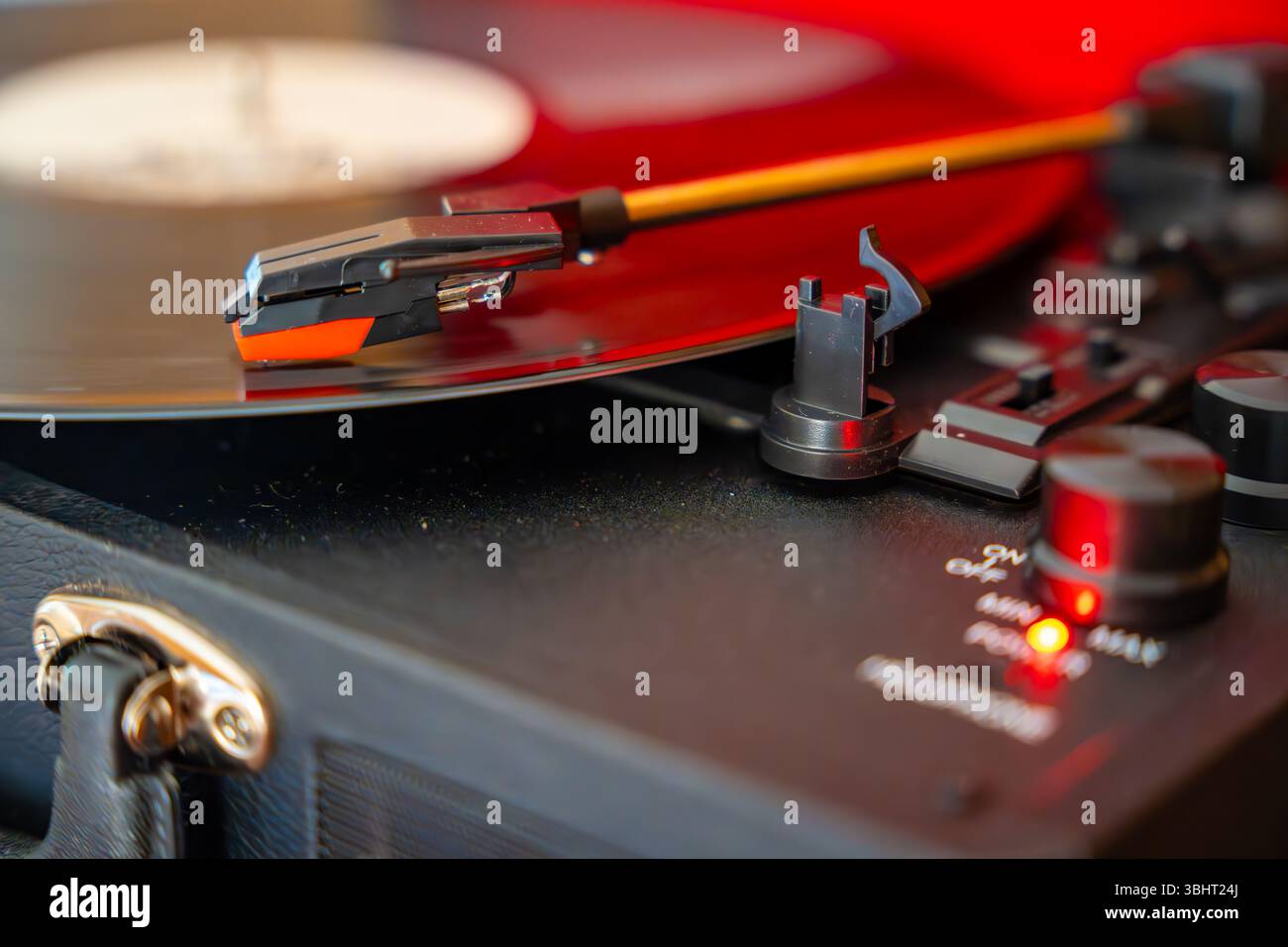 Close-up of record player needle tracking vinyl grooves during playback. Analog sound detail capturing retro music atmosphere. Stock Photo