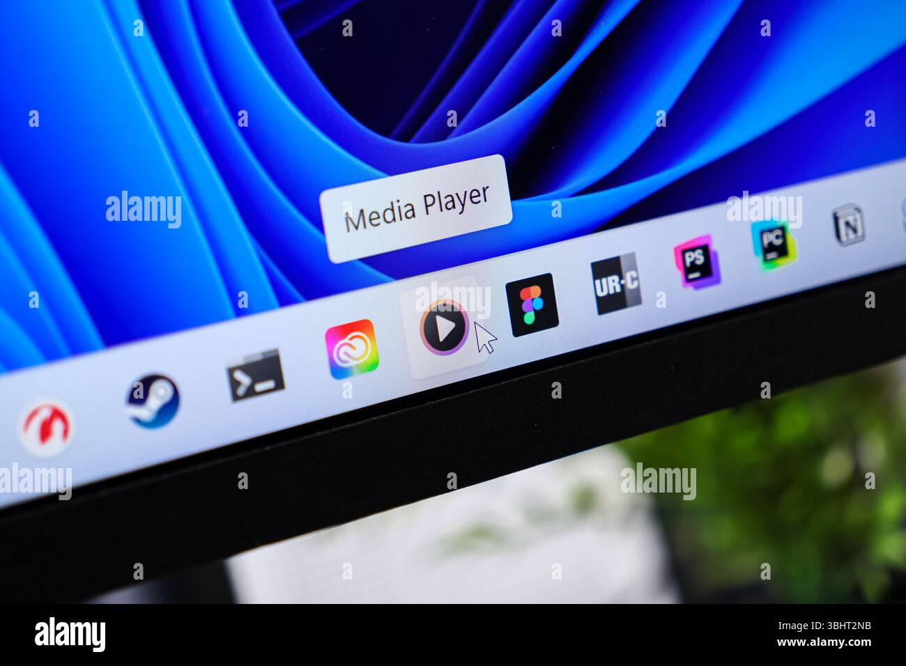 Poznan, Poland - June 6, 2025: Close-up of a vibrant blue desktop wallpaper and a taskbar featuring software icons, highlighting the Media Player appl Stock Photo