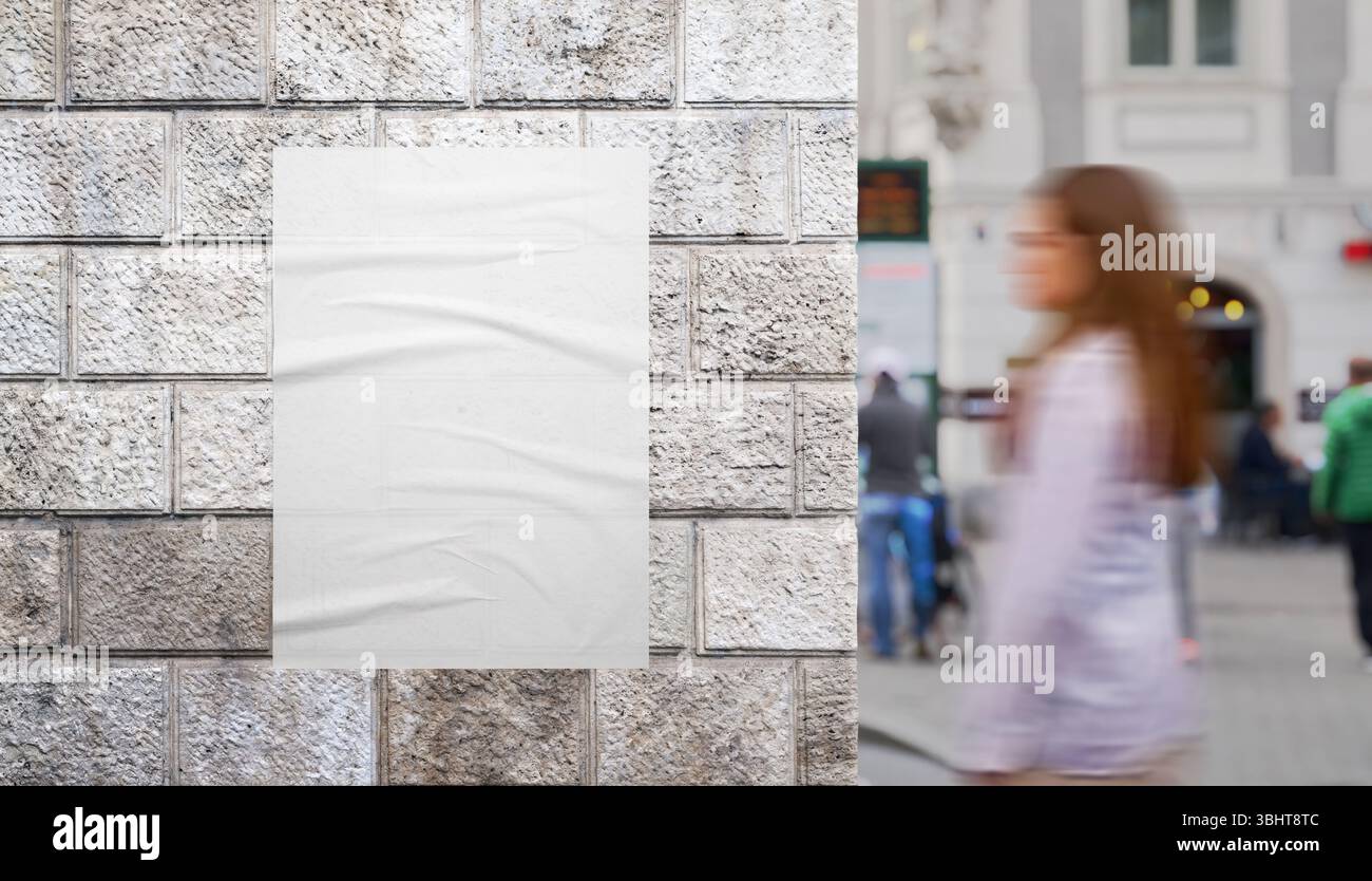 Girl walking past urban poster mockup on city building wall in pedestrian zone. Perfect for showcasing creative print or ad design Stock Photo