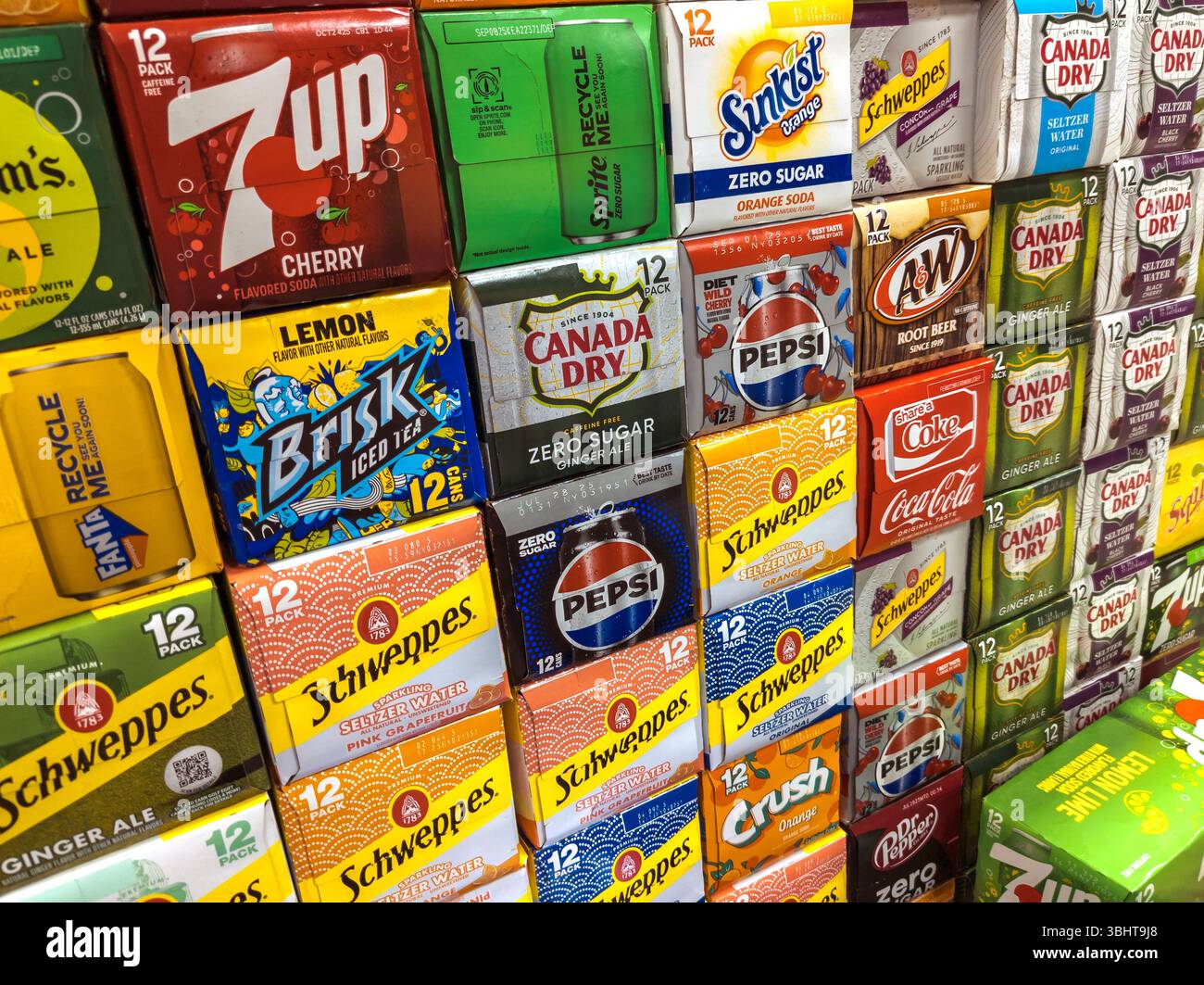 Boxes containing 12-packs of cans of soda and other beverages in a multitude of brands in a grocery store in Chelsea in New York on Thursday, May 29, 2025. The average American drinks one can of soda a day which works out to be about 32 pounds of sugar a year. (© Richard B. Levine) Stock Photo