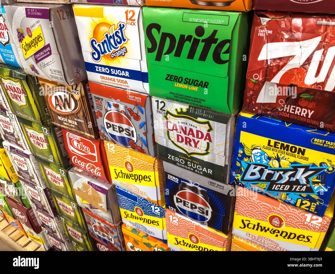 Boxes containing 12-packs of cans of soda and other beverages in a multitude of brands in a grocery store in Chelsea in New York on Thursday, May 29, 2025. The average American drinks one can of soda a day which works out to be about 32 pounds of sugar a year. (© Richard B. Levine) Stock Photo
