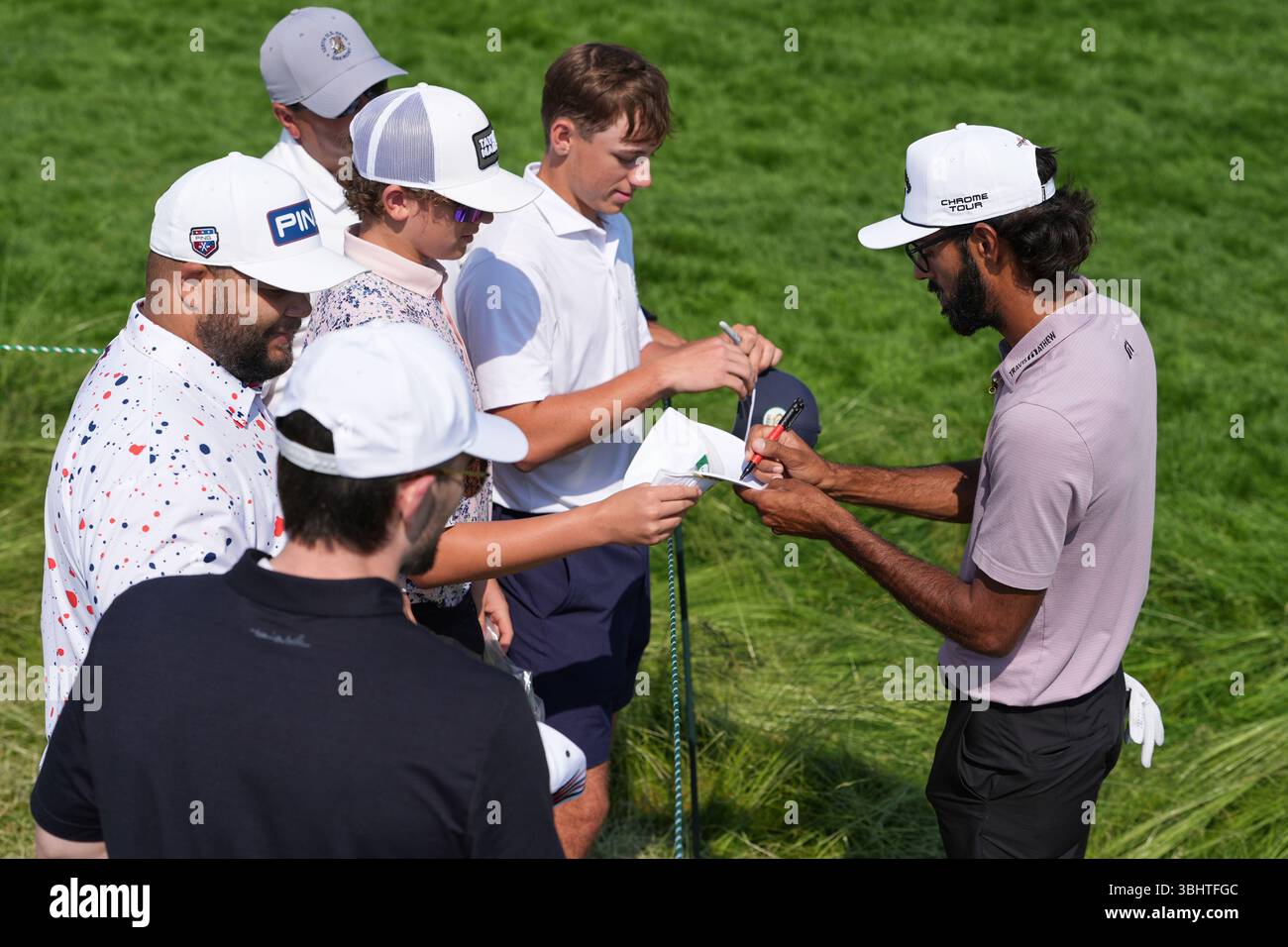 Akshay Bhatia signs autographs for fans during a practice round ahead of the U.S. Open golf tournament at Oakmont Country Club Wednesday, June 11, 2025, in Oakmont, Pa. (AP Photo/Seth Wenig Stock