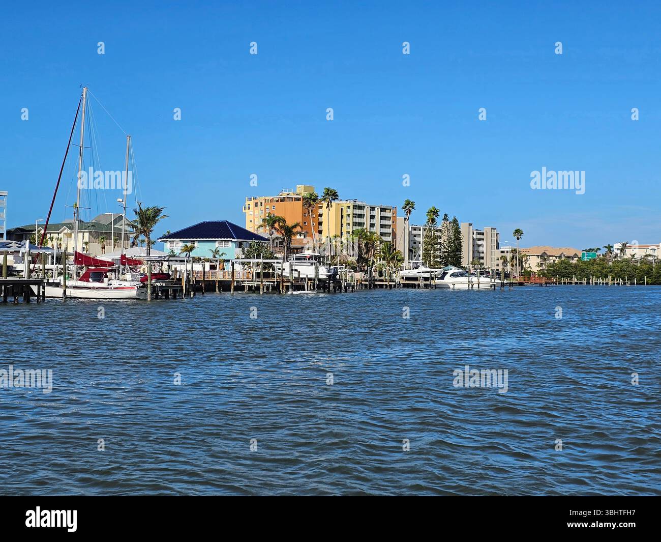 Indian Shores, The Narrows, Florida. View of waterfront homes with private docks and highrise condos from the Intracoastal Waterway. - Smartphone Captured Stock Image