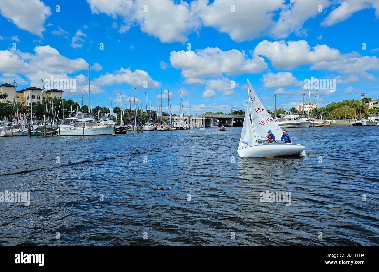 Dinghy sailing in Melbourne harbor, Florida.  Two students learn to tack on a small sailboat in the harbor. - Smartphone Captured Stock Image