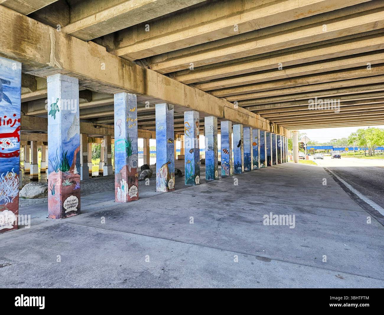 Unique mural in Melbourne, Florida. The undersea themed mural is painted on the concrete pillars supporting a road bridge crossing Melbourne harbor. - Smartphone Captured Stock Image