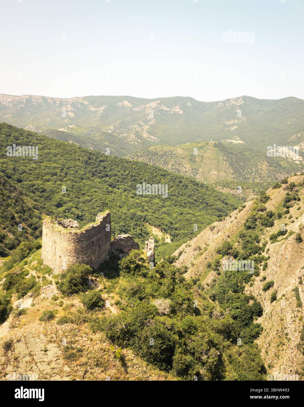 Aerial view of Armazi Fortress ruins on steep ridge with tilted rock ...