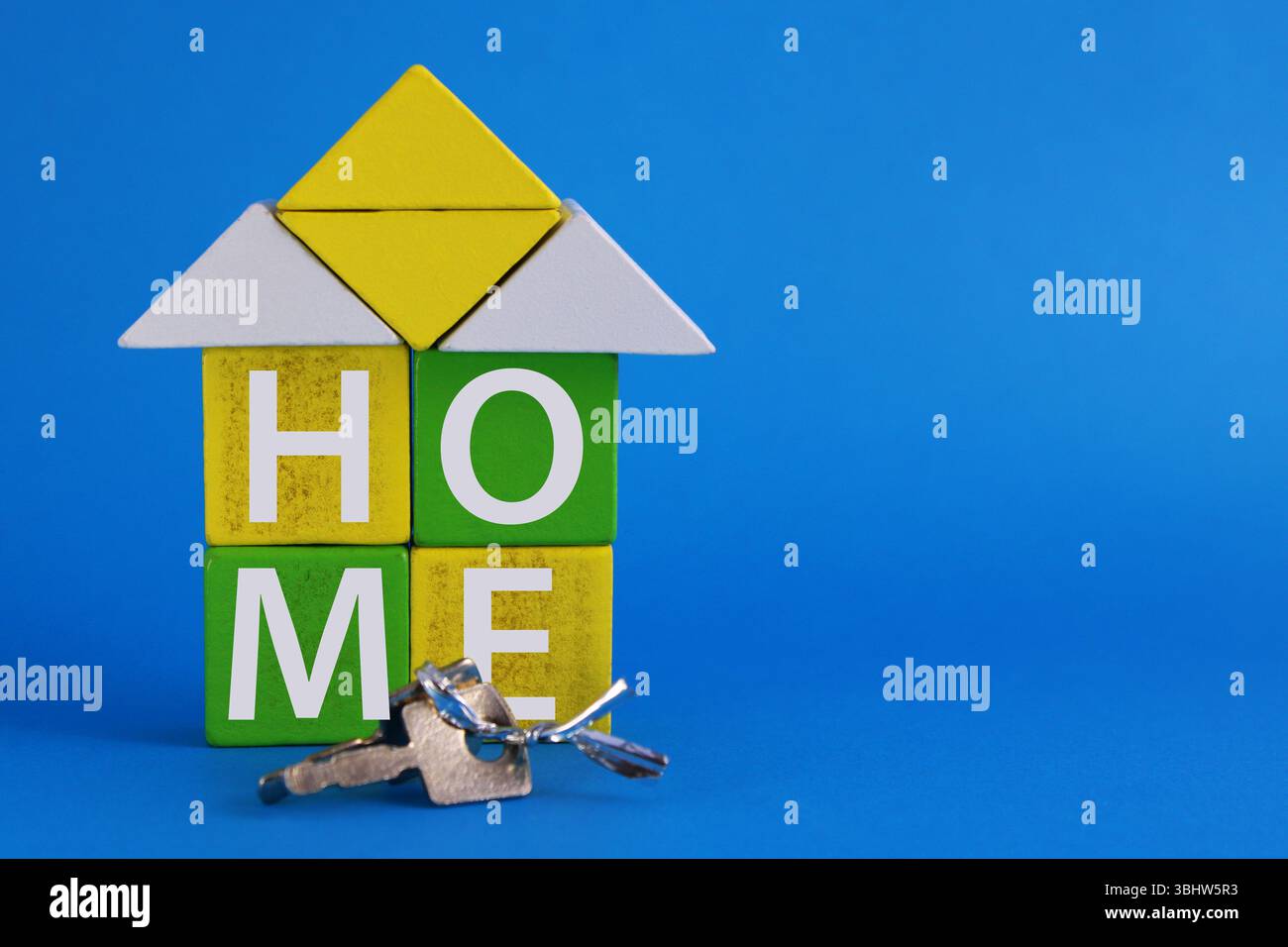 HOME, keys and a house built with wooden geometric shapes Stock Photo ...