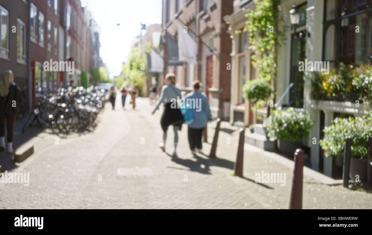 Blurred city street in amsterdam with defocused pedestrians, bicycles ...