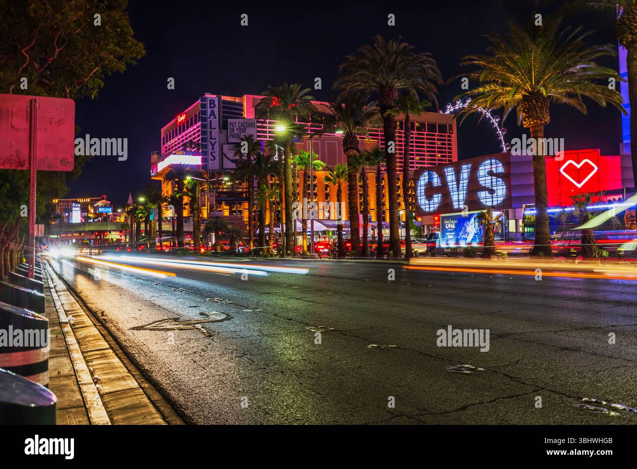 Night view of Las Vegas Strip with Bally's hotel, CVS pharmacy, palm ...
