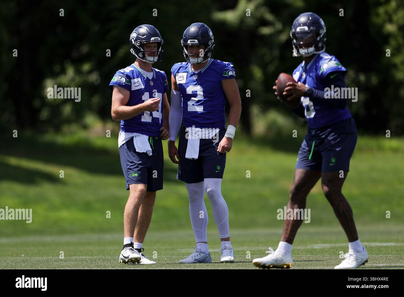 Seattle Seahawks quarterbacks Sam Darnold, left, and Drew Lock, center ...