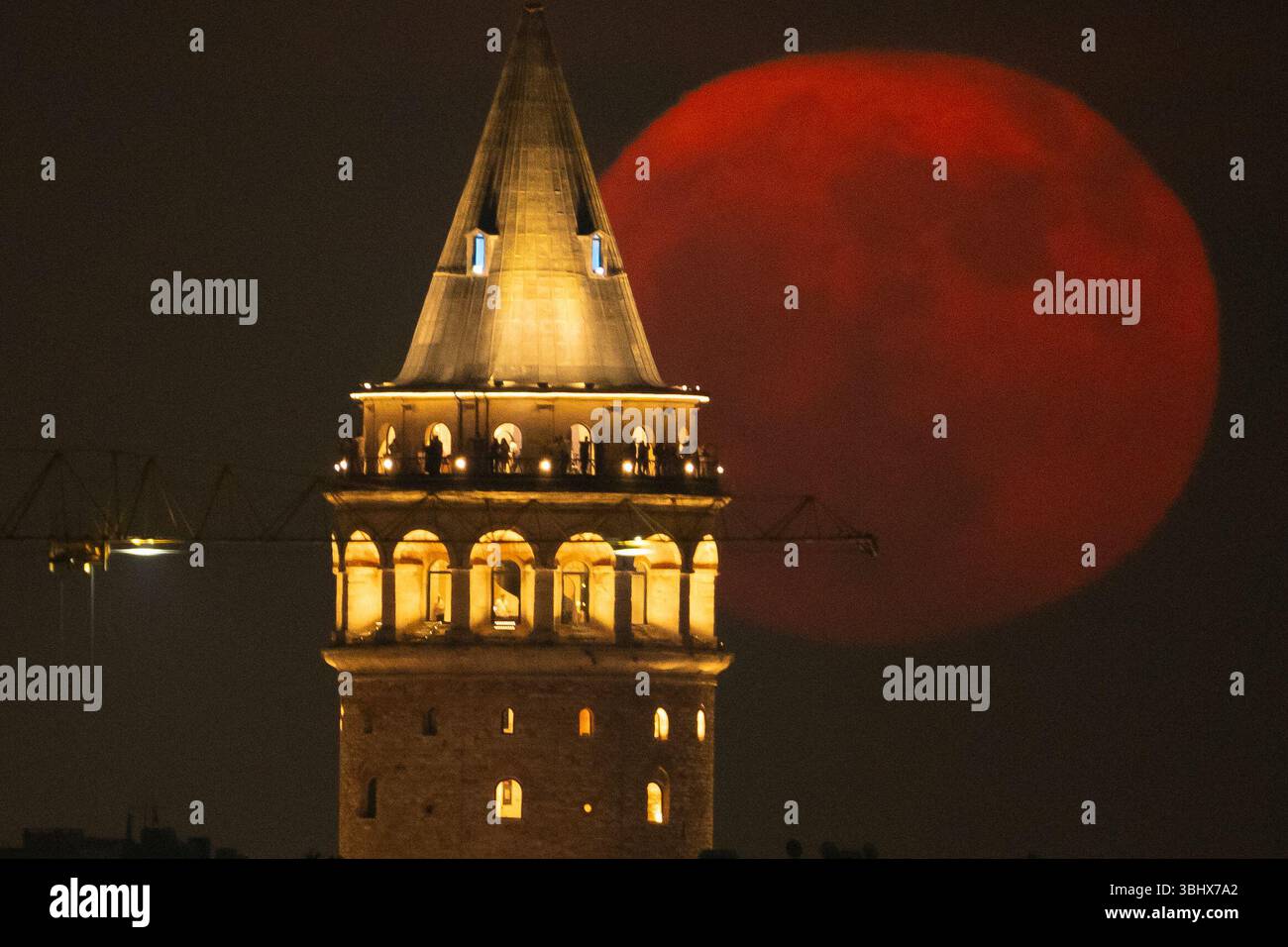 The strawberry Moon rises behind Galata Tower in Istanbul, Turkey ...