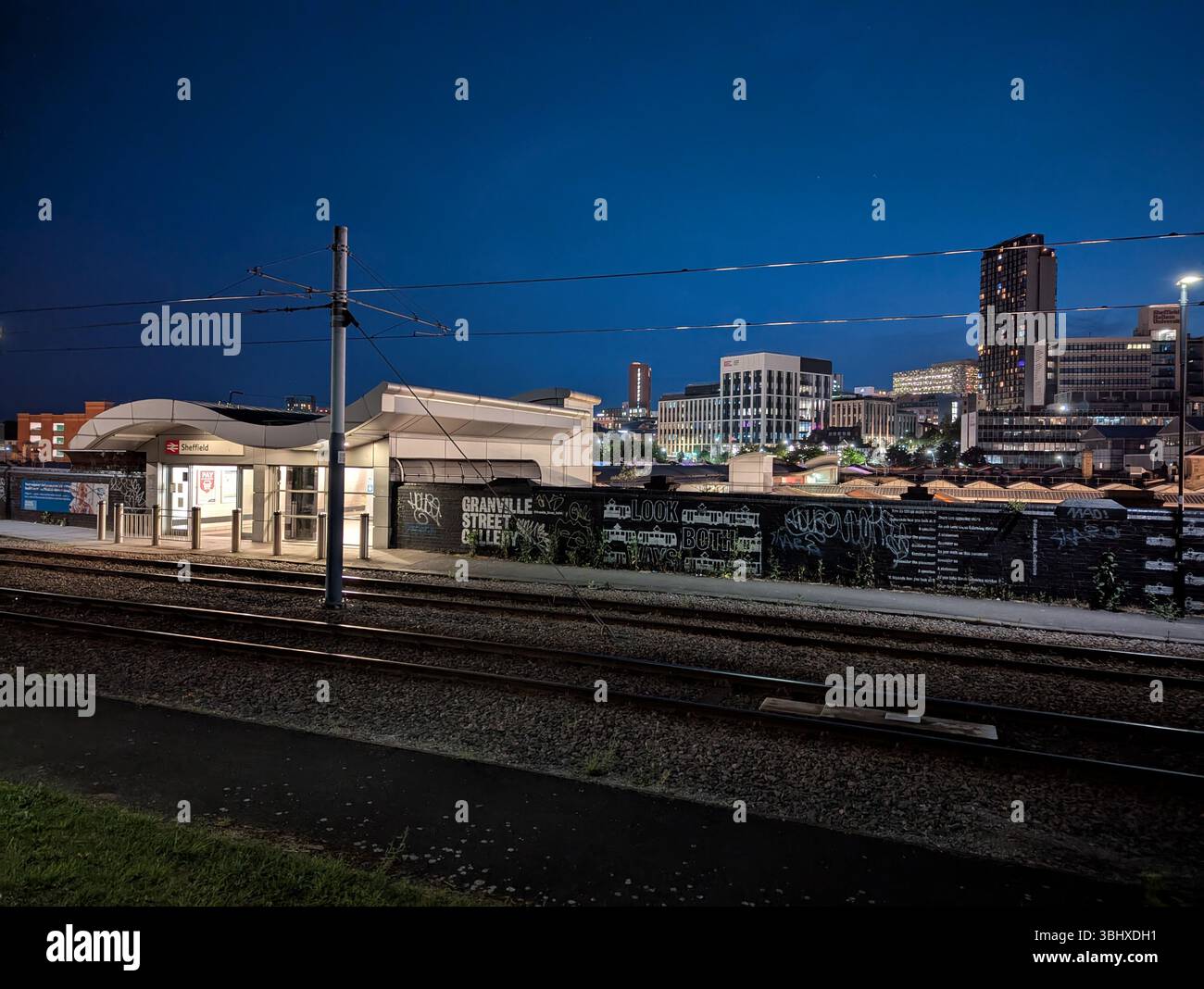 Sheffield city centre at night, a vibrant urban landscape showcasing the  illuminated railway station and tram stop - Smartphone Captured Stock Image