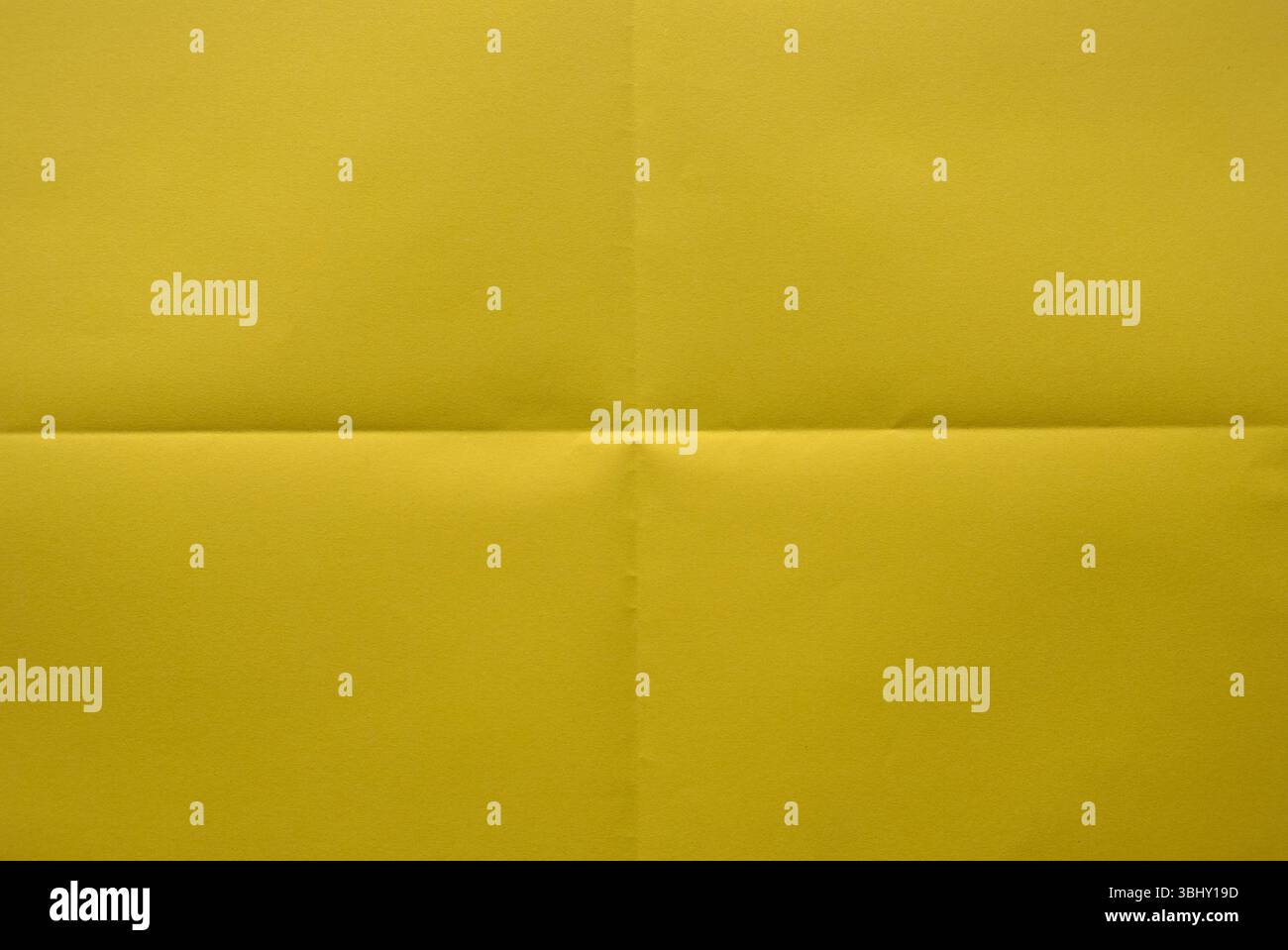 Folded yellow color paper for background. Stock Photo