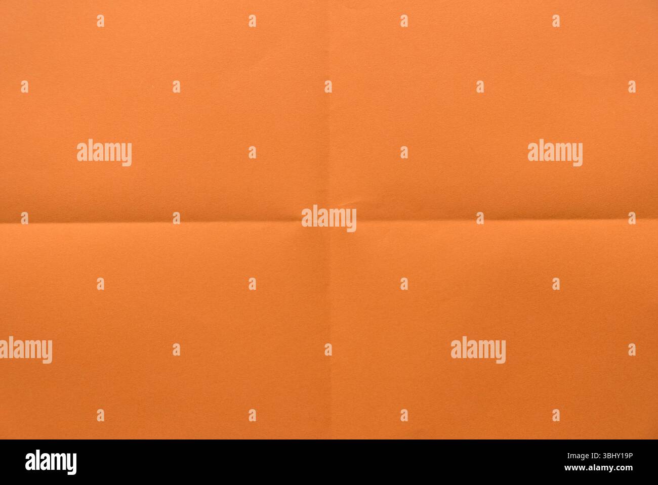 Folded orange color paper for background. Stock Photo