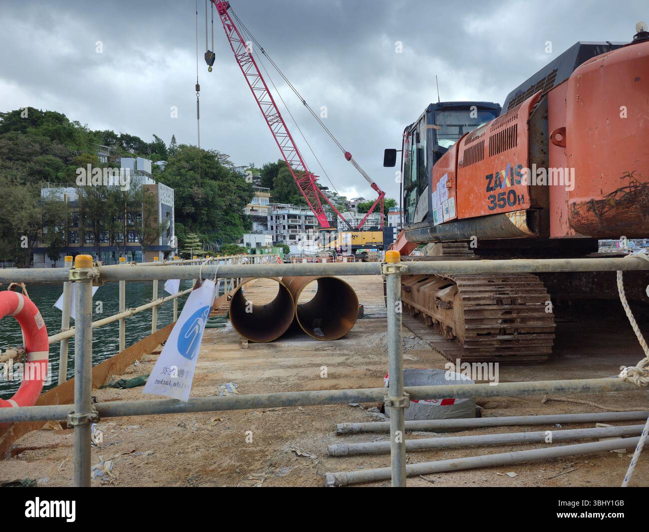 June 2025 , Yung Shue Wan, Lamma Island, Hong Kong. Construction workers working on the new pie - Smartphone Captured Stock Image