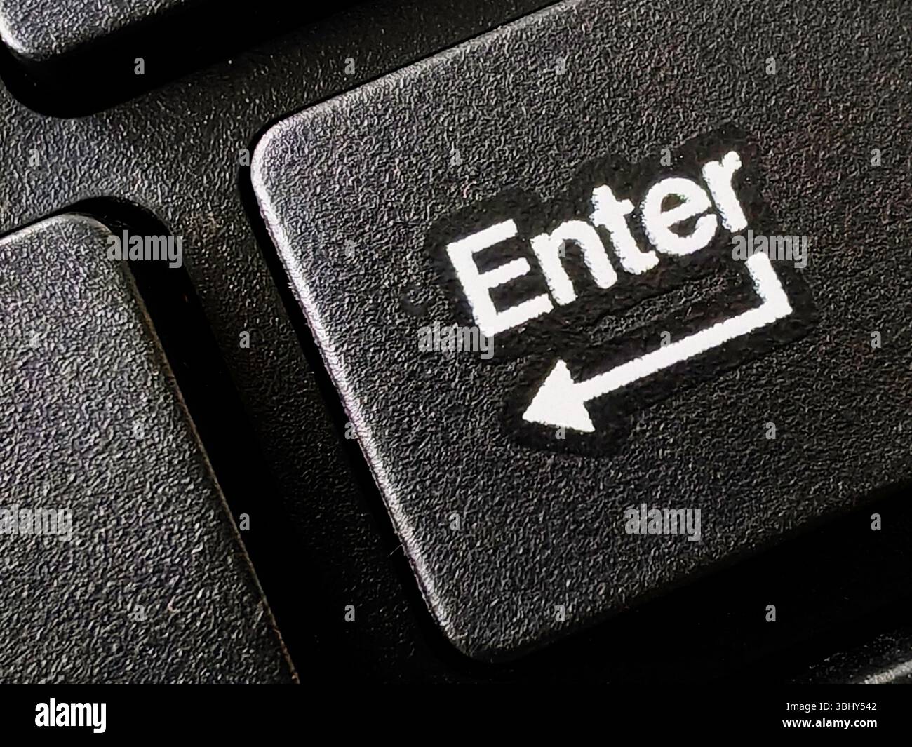 Close up of enter button on computer keyboard. Stock Photo