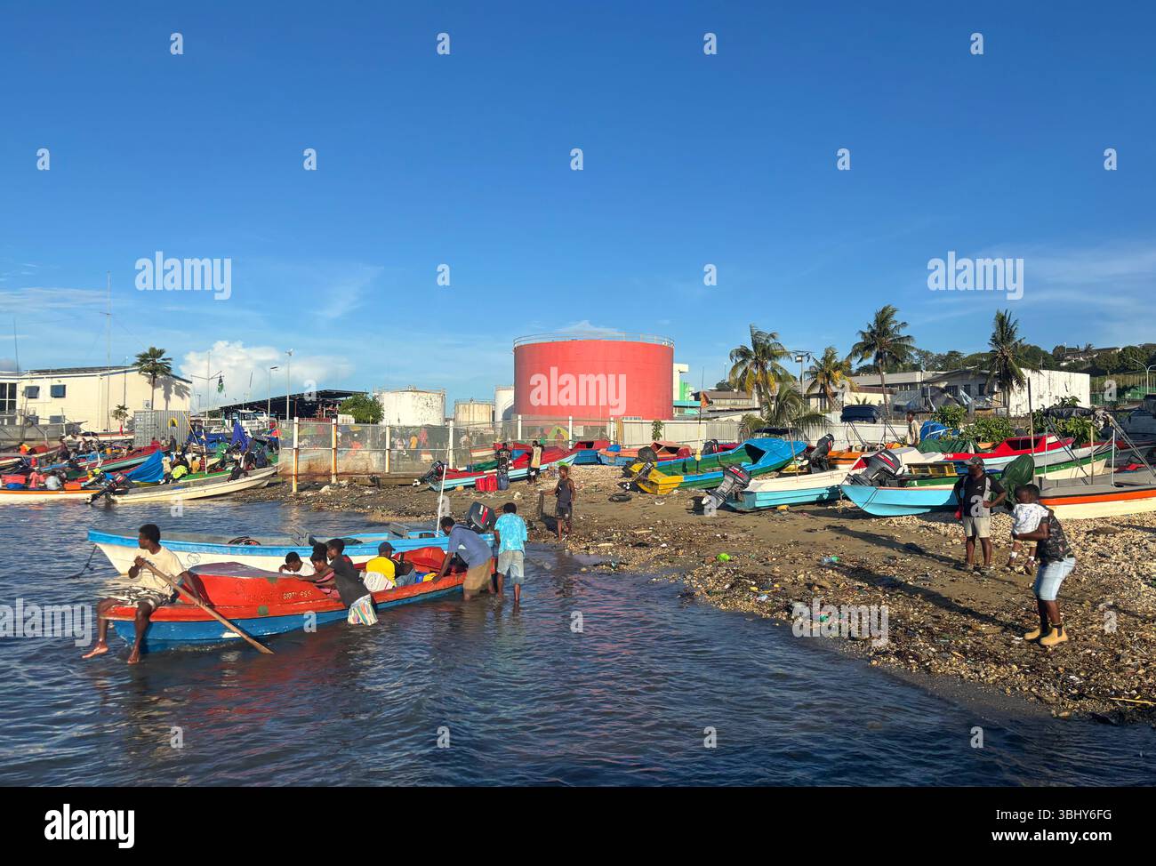 People setting off in water taxi, beach at Point Cruz, Honiara, Solomon Islands. No MR or PR - Smartphone Captured Stock Image