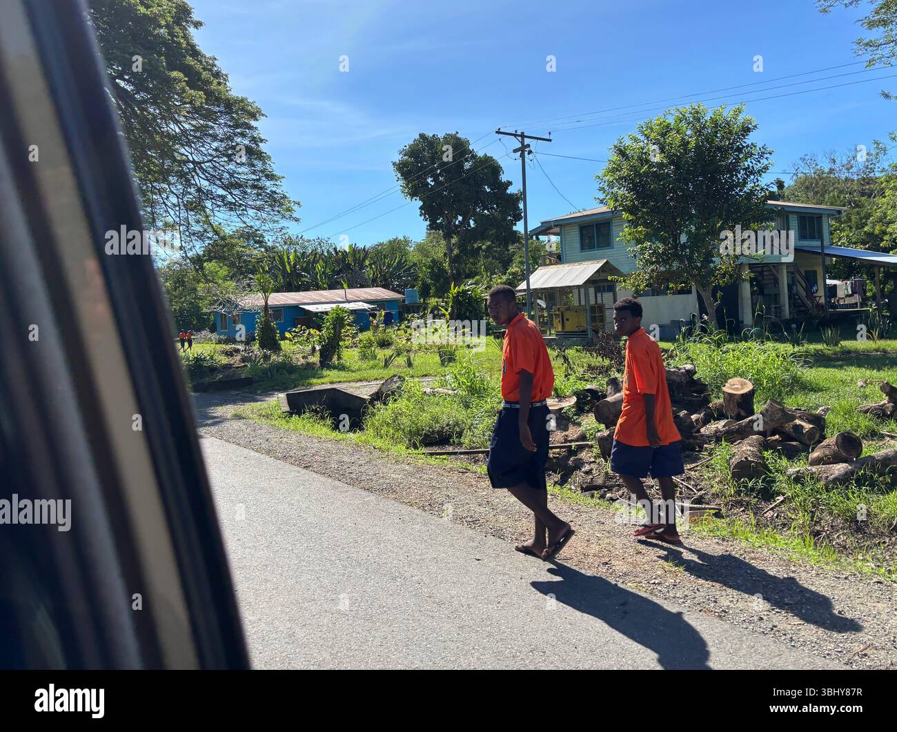 Schoolboys along the road heading into Honiara, Guadalcanal, Solomon Islands. No MR or PR - Smartphone Captured Stock Image