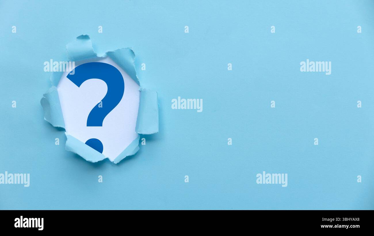 Torn Paper Revealing Blue Question Mark on Light Blue Background Stock Photo