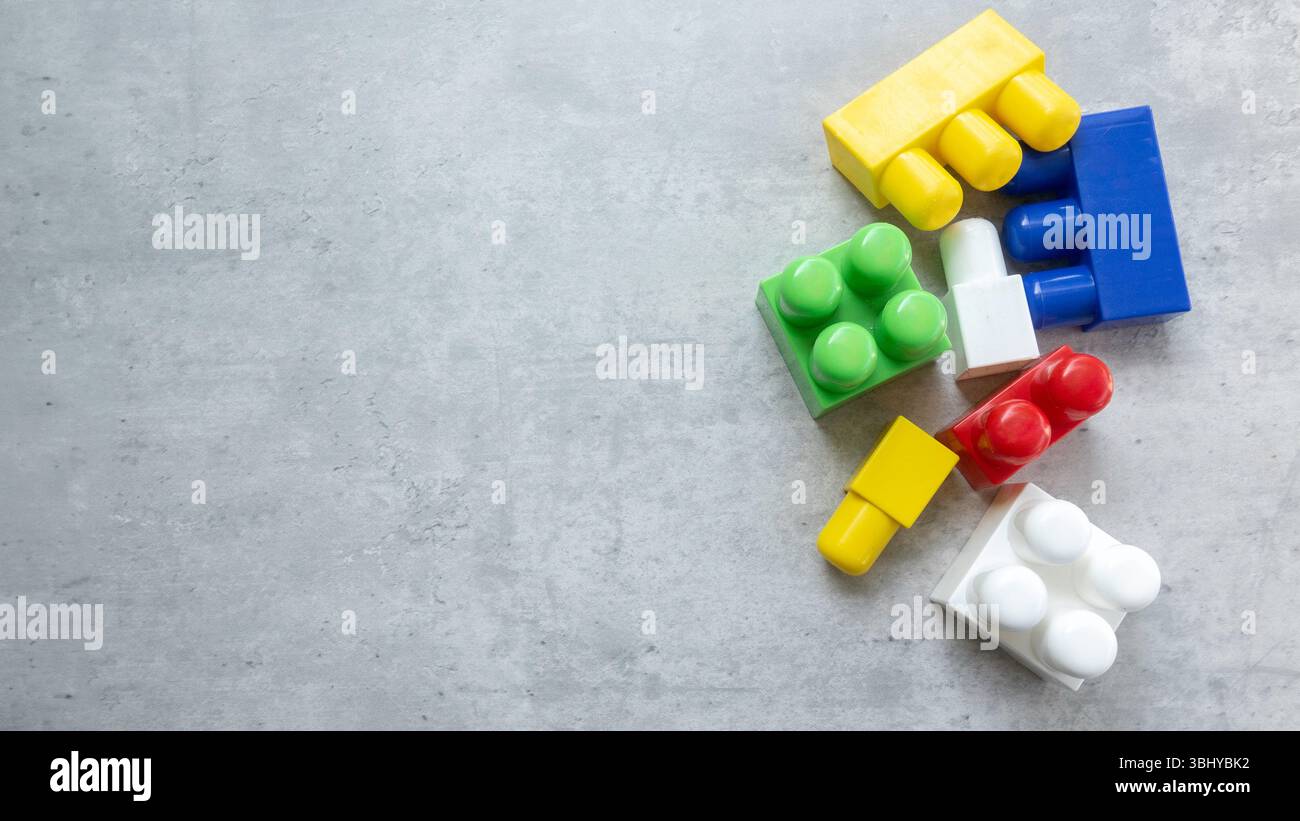 Colorful Plastic Building Blocks on Gray Surface Stock Photo