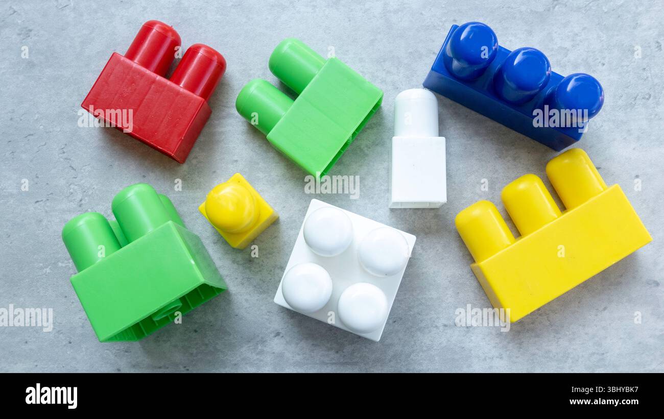 Colorful Plastic Building Blocks on Gray Surface Stock Photo