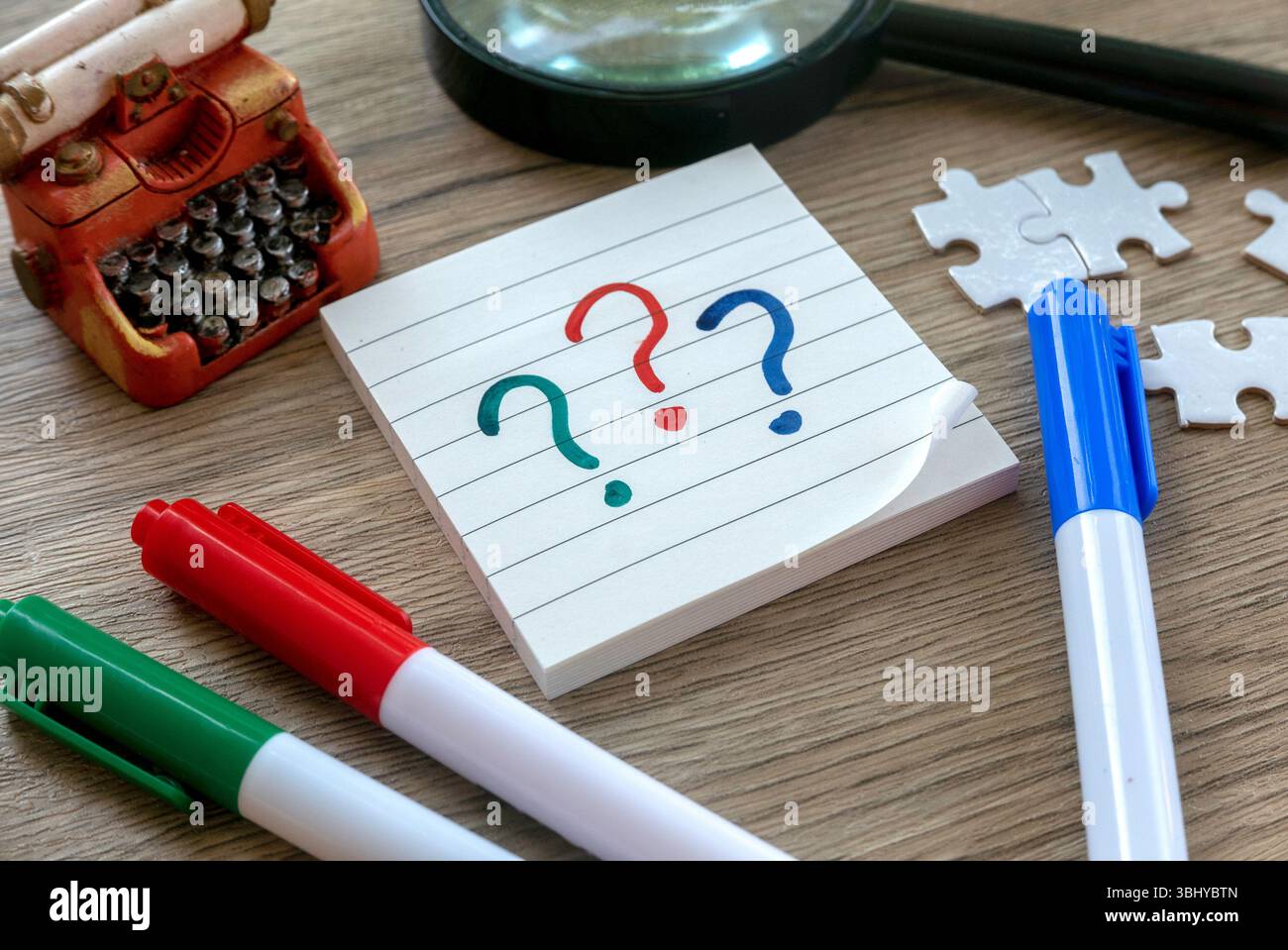 Colorful Question Marks on Notepad with Pens, Puzzle Pieces, Magnifying ...