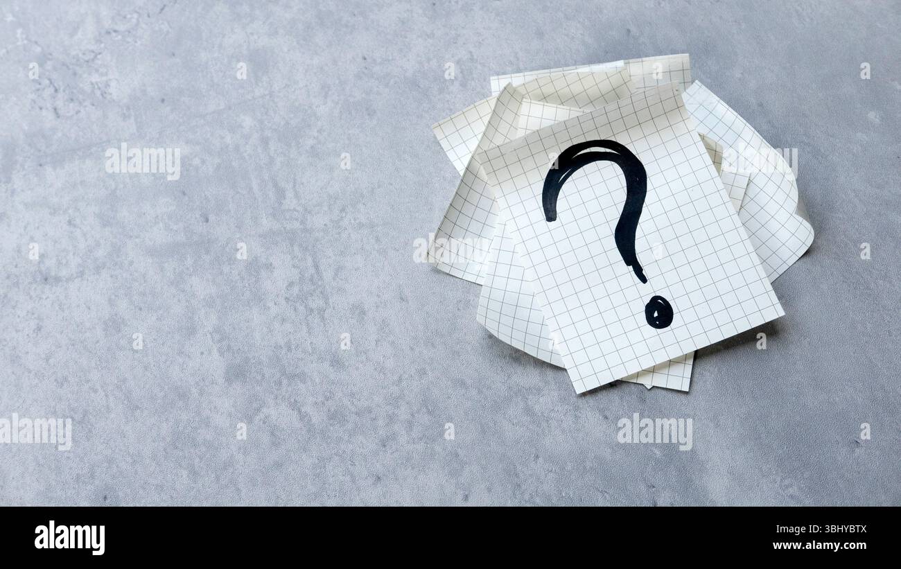 Question Mark on Paper Sheets with gray Background Stock Photo