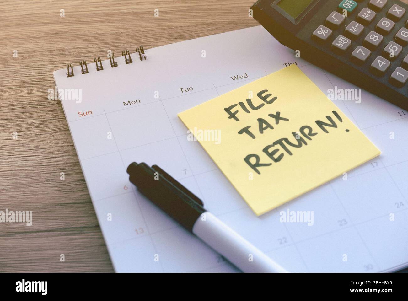 Reminder to File Tax Return with Calendar, Sticky Note, Pen, and ...