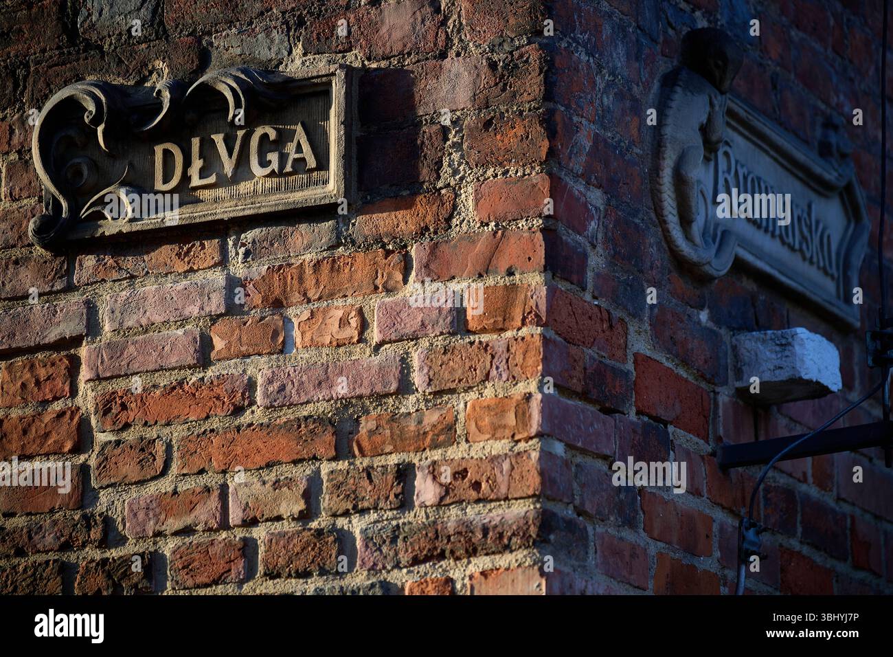 Street Signs on a Historic Brick Wall in Gdańsk: Długa and Kramarska ...
