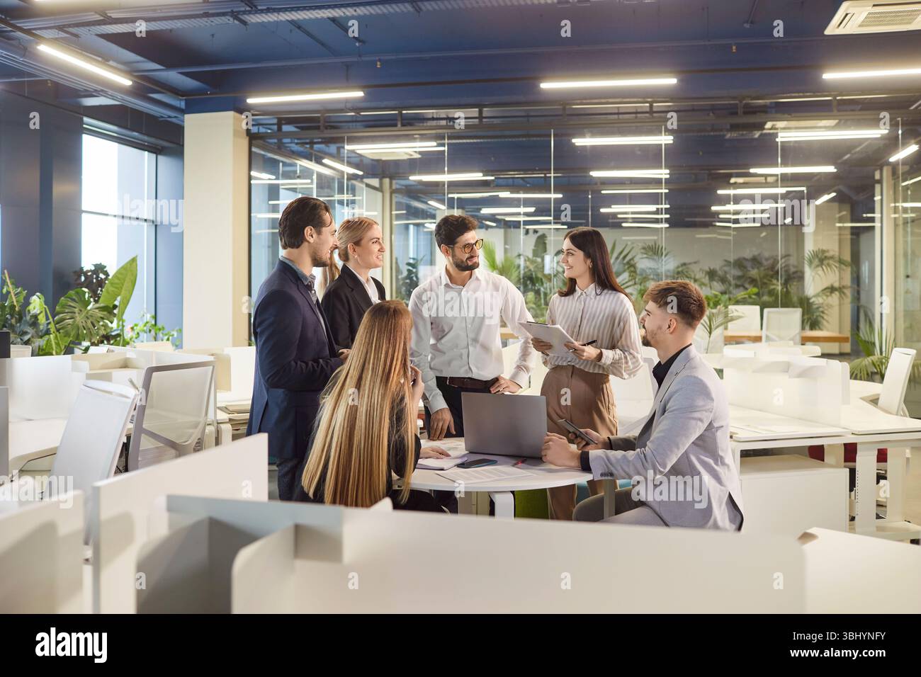 Team Collaborating In Office Meeting With Documents Stock Photo