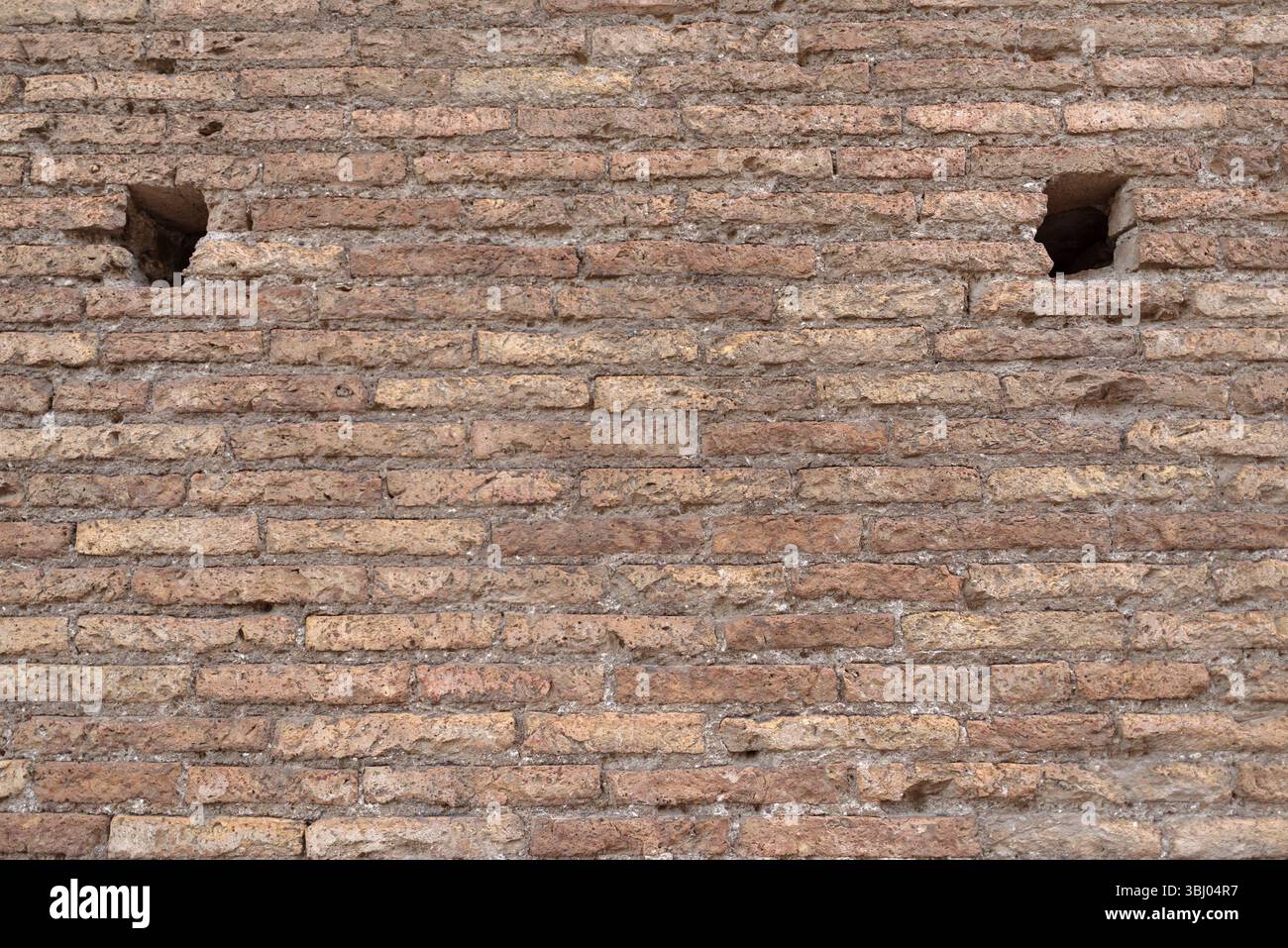 Weathered ancient Roman brick wall revealing aged surface, eroded ...